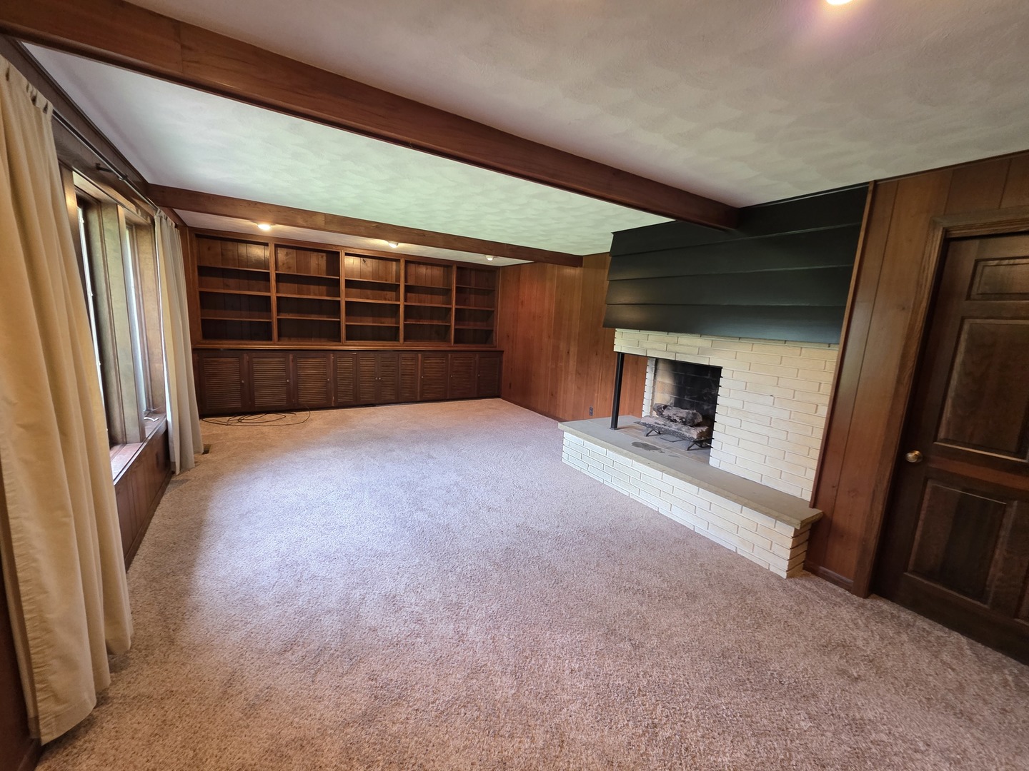 1546 Wheeler Street Woodstock, IL 60098 - Photo 16 of 32 a view of an empty room with a fireplace and a window