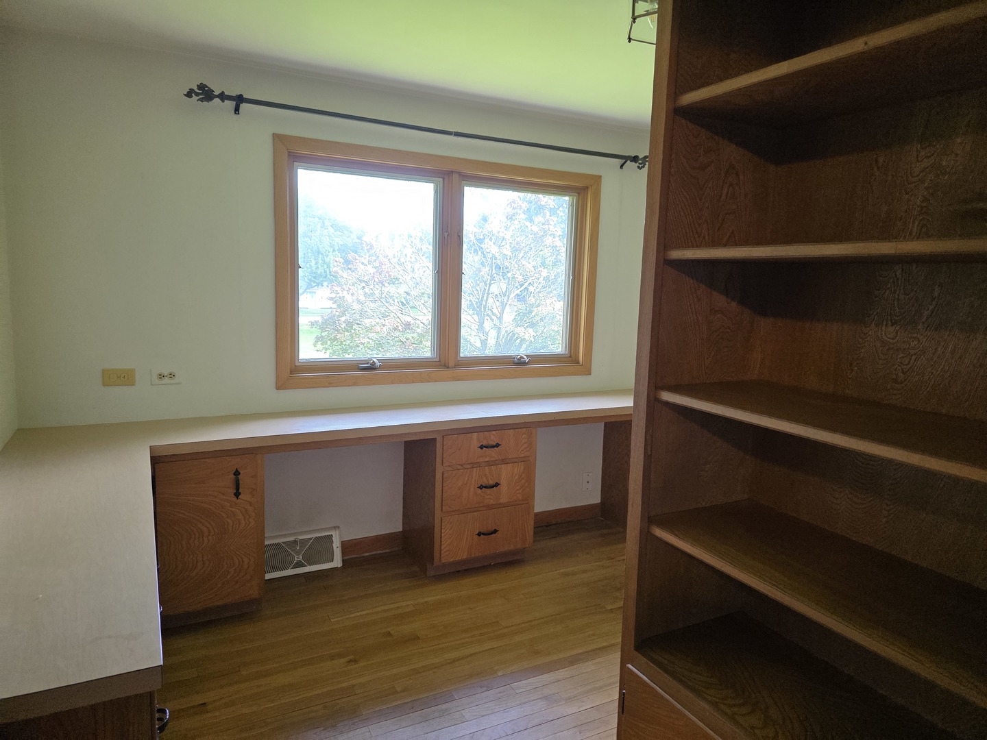 1546 Wheeler Street Woodstock, IL 60098 - Photo 21 of 32 a view of an empty room with wooden floor and a window
