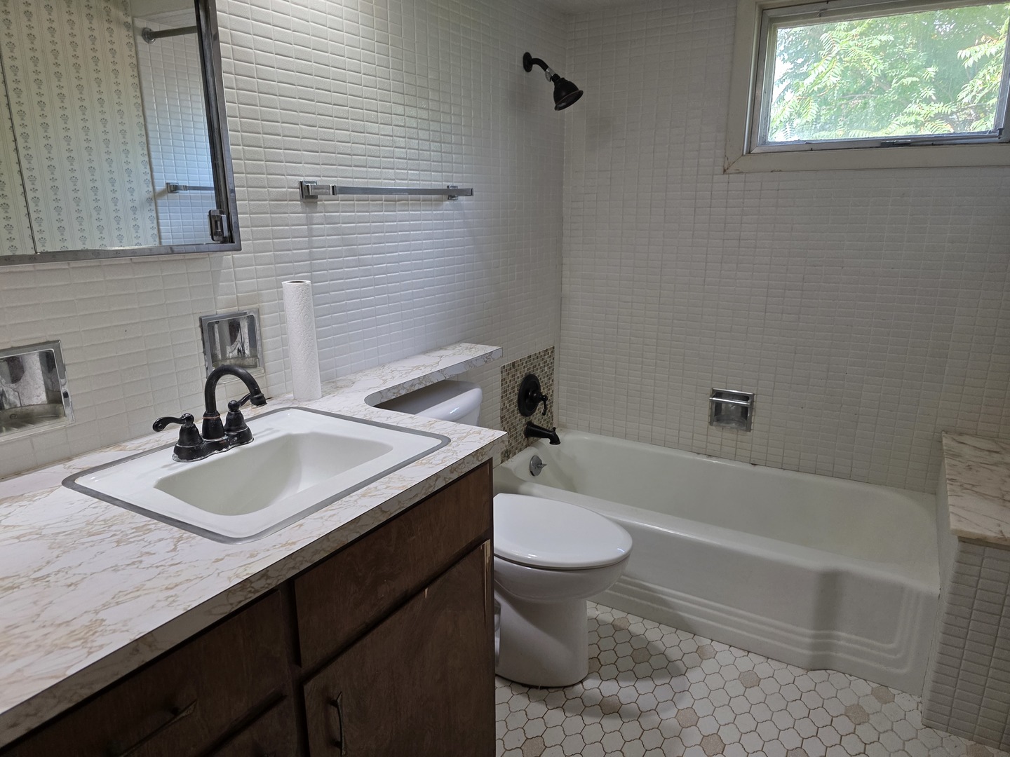 1546 Wheeler Street Woodstock, IL 60098 - Photo 24 of 32 a bathroom with a granite countertop sink toilet and bathtub