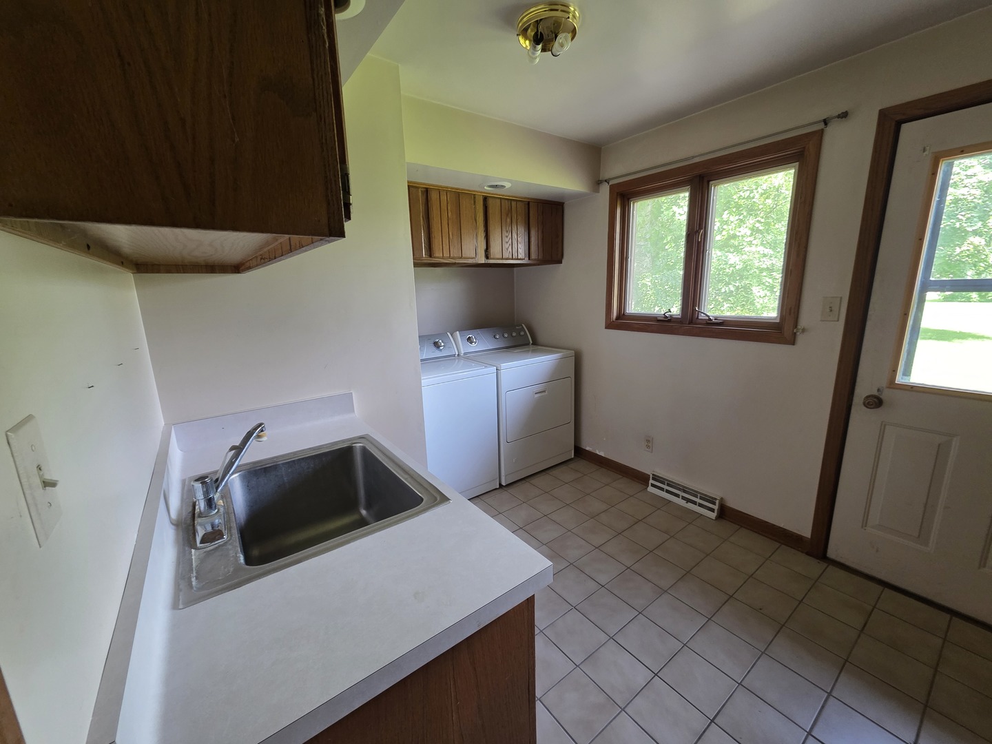 1546 Wheeler Street Woodstock, IL 60098 - Photo 27 of 32 a kitchen with a refrigerator and a stove
