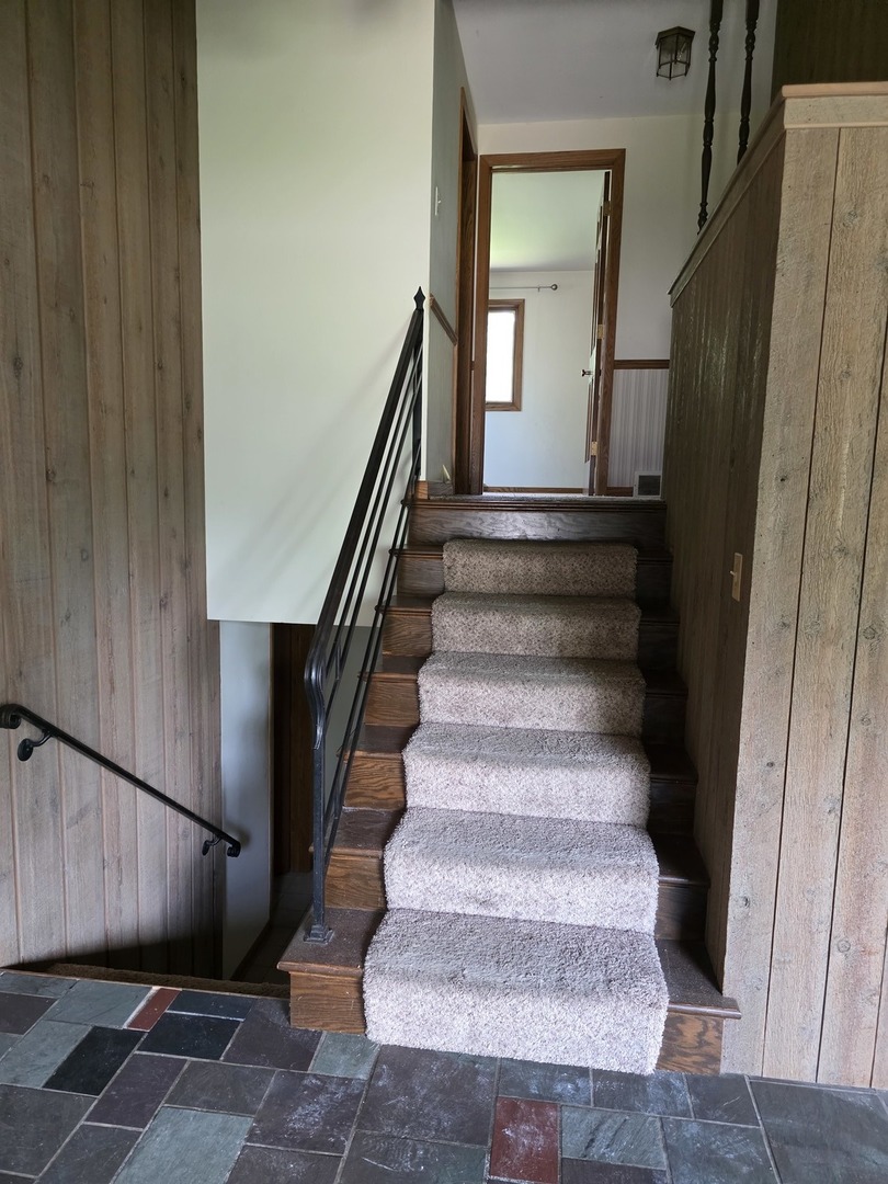 1546 Wheeler Street Woodstock, IL 60098 - Photo 8 of 32 a view of staircase with wooden floor and fan