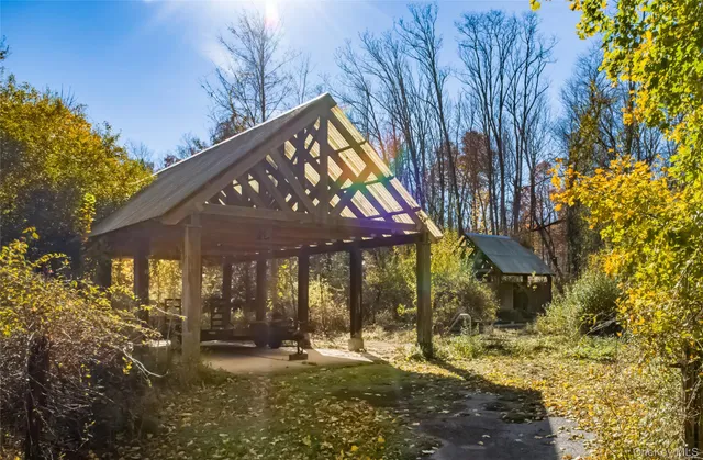 a view of a house with backyard and sitting area