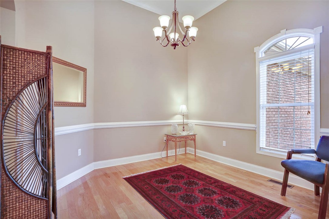 104 P-10-51 Anderson, SC 29621 - Photo 4 of 35 Formal dining room features a chair rail and hardw