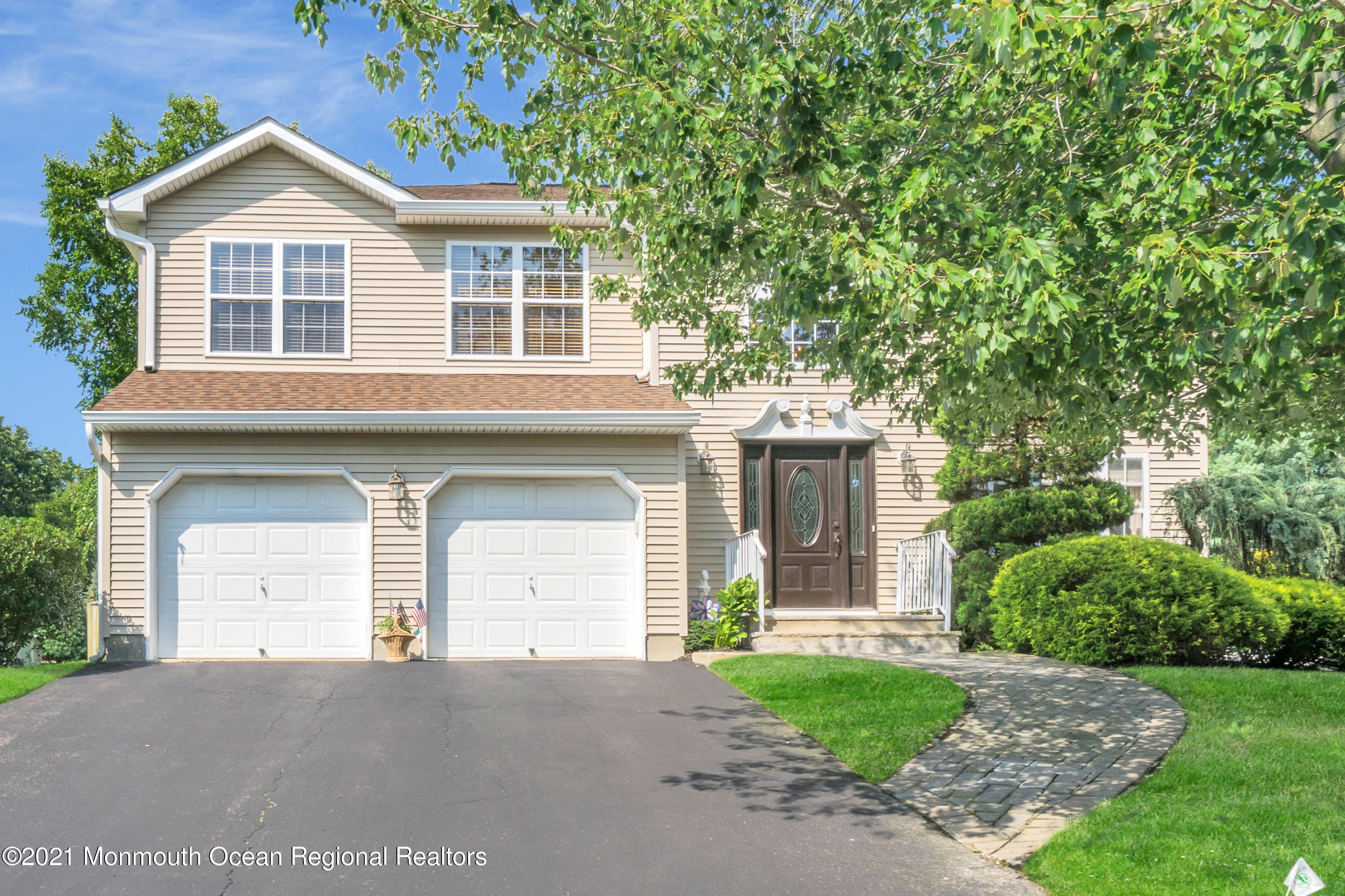 7 Sun Hollow Road Howell, NJ 07731 - Photo 1 of 31 a front view of a house with a yard and garage