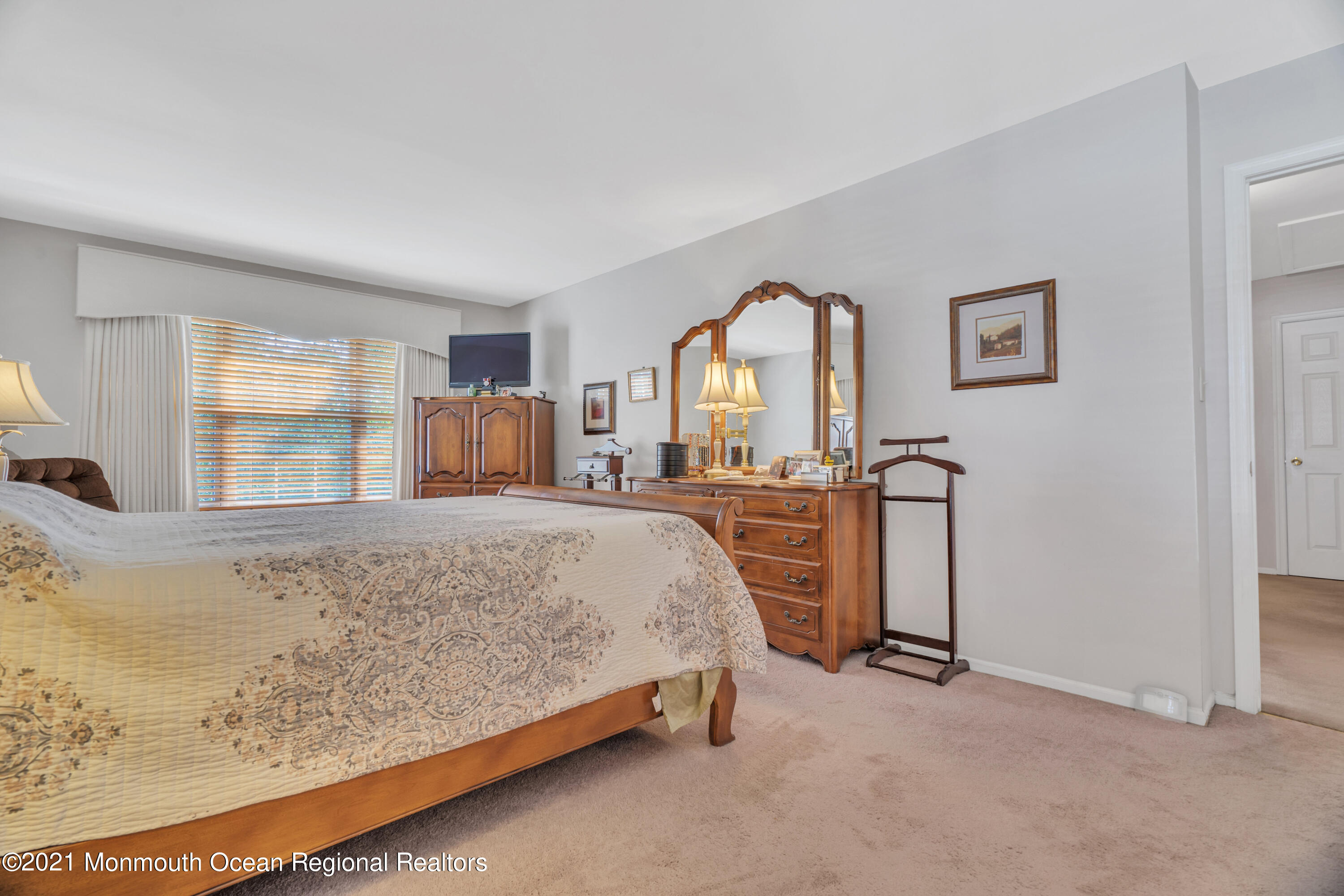 7 Sun Hollow Road Howell, NJ 07731 - Photo 18 of 31 a spacious bedroom with a bed and a dresser with mirror