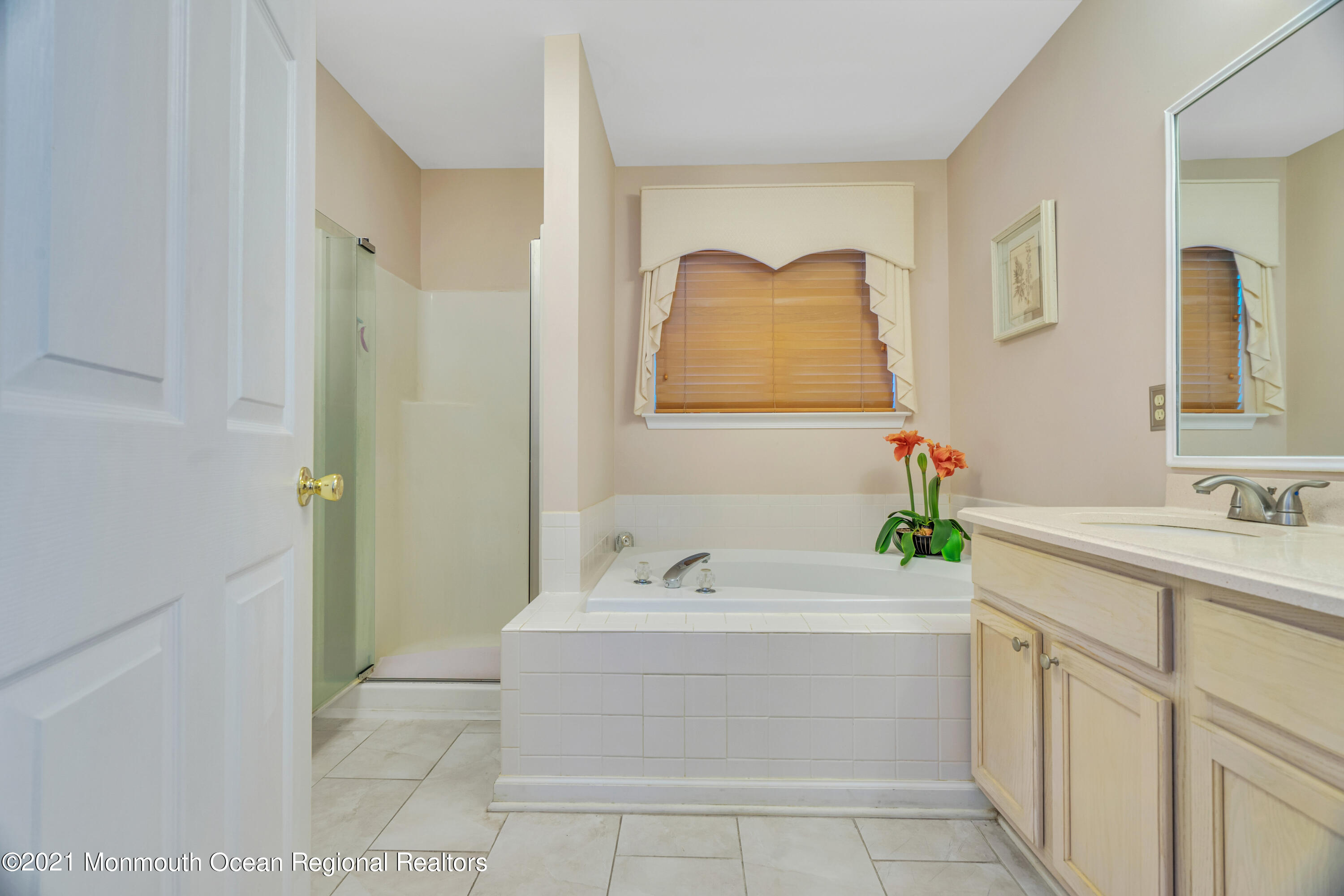 7 Sun Hollow Road Howell, NJ 07731 - Photo 19 of 31 a bathroom with a tub a sink and mirror