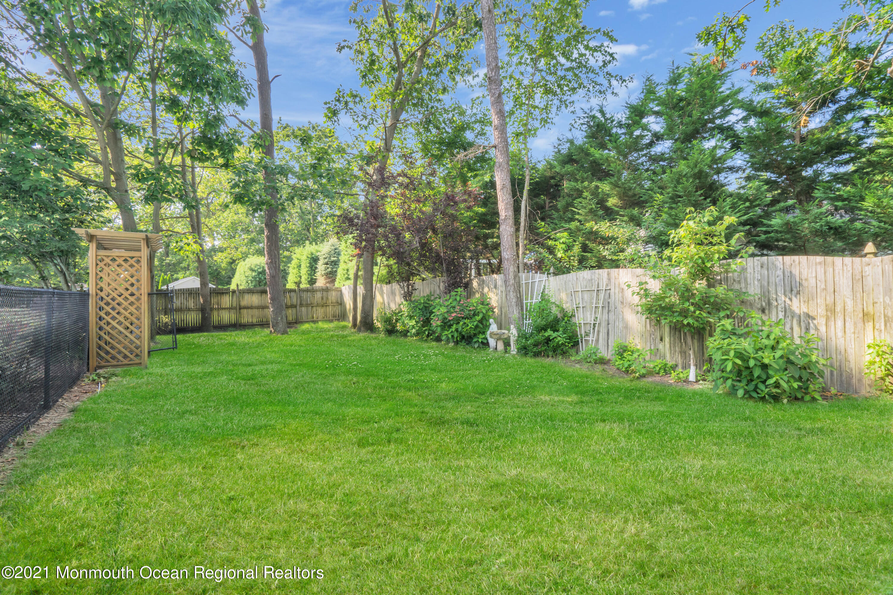 7 Sun Hollow Road Howell, NJ 07731 - Photo 30 of 31 a view of a backyard with large trees and plants