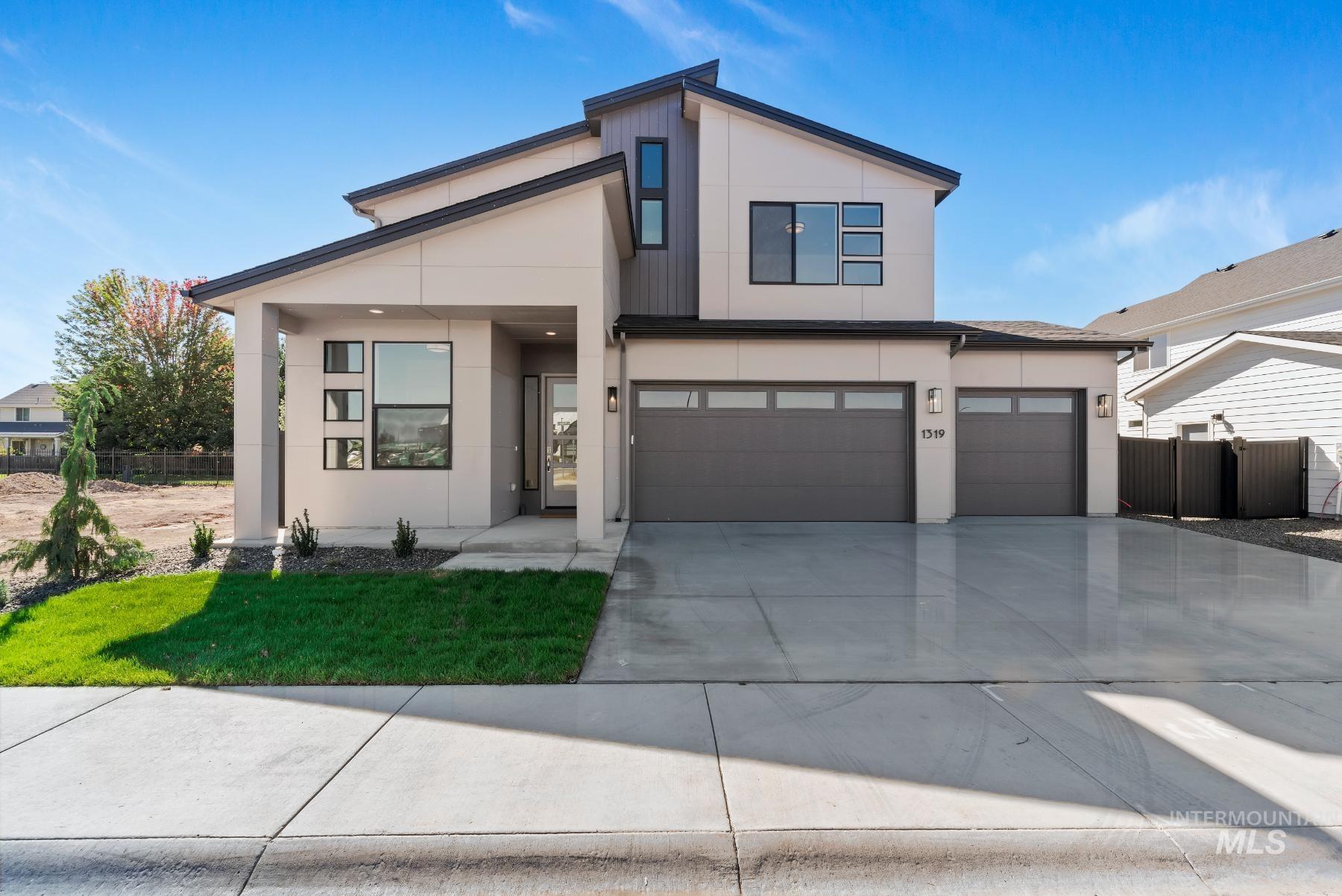 Contemporary home featuring concrete driveway, stucco siding, and an attached garage