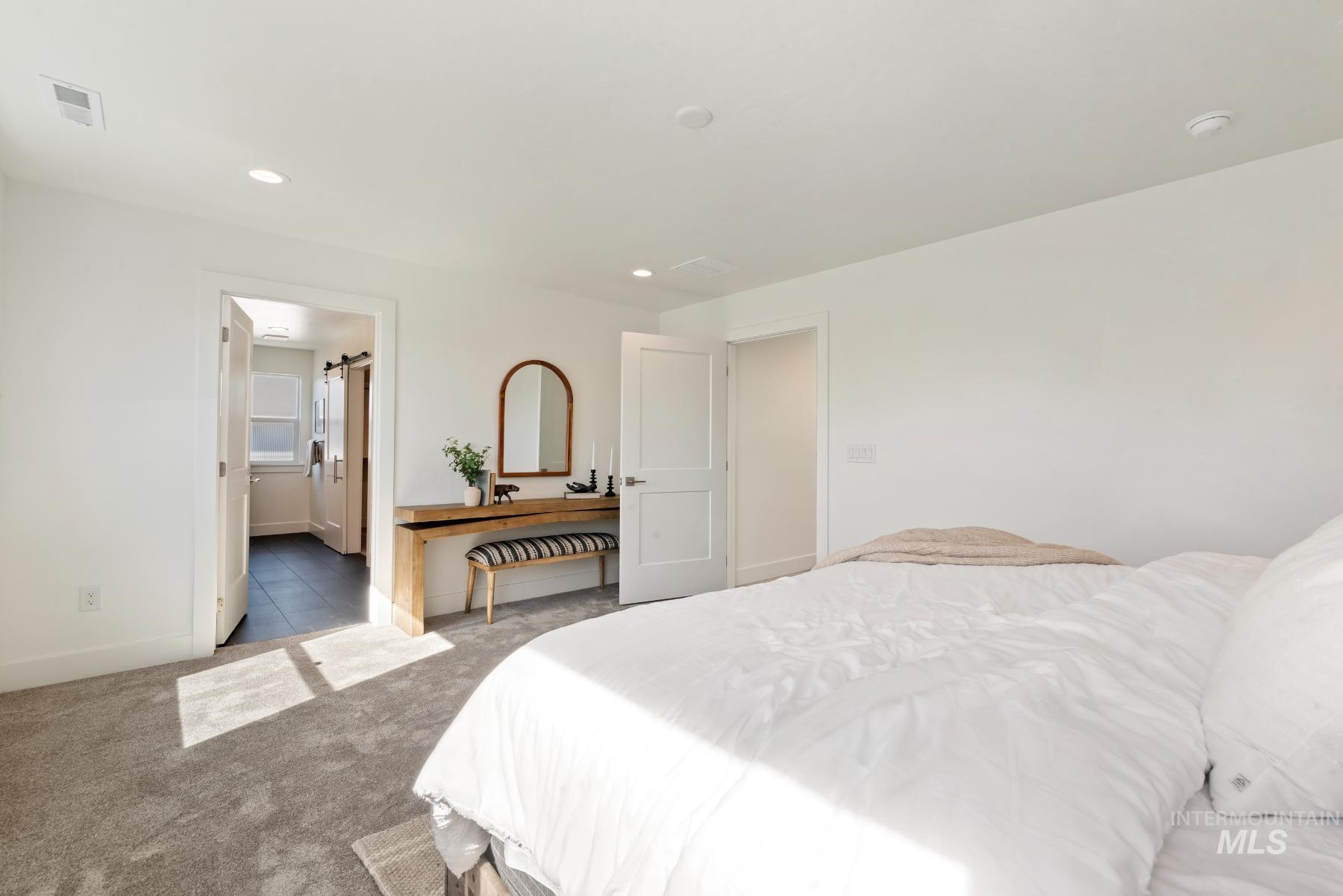 1319 West Malbar Street Meridian, ID 83646 - Photo 16 of 31 Bedroom with carpet flooring, recessed lighting, and a barn door