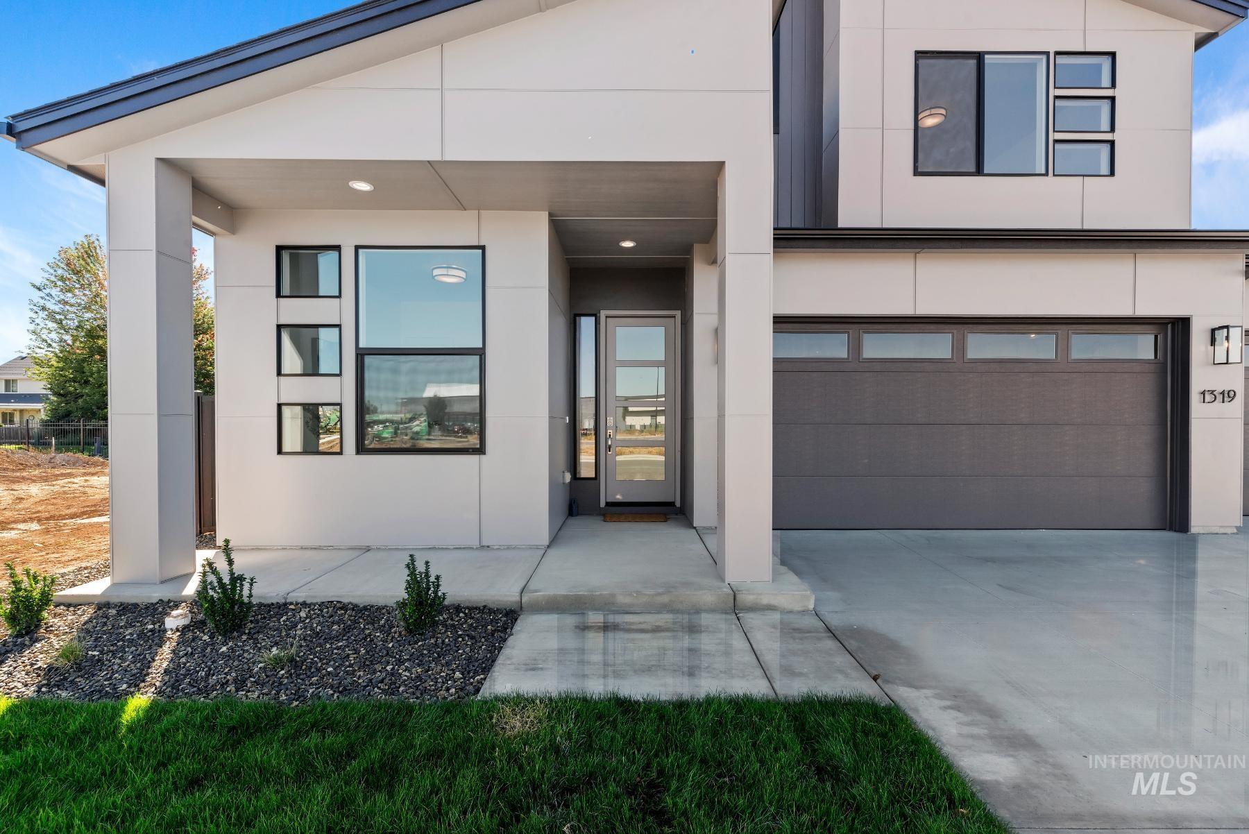 1319 West Malbar Street Meridian, ID 83646 - Photo 2 of 31 View of front of property featuring stucco siding, concrete driveway, and an attached garage