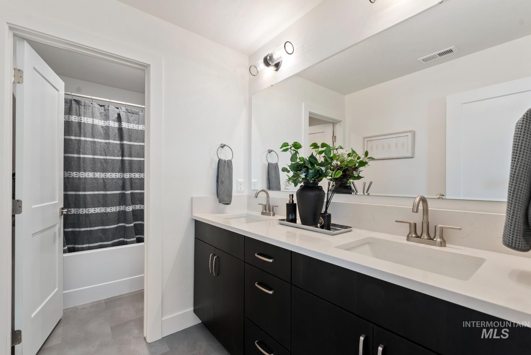 1319 West Malbar Street Meridian, ID 83646 - Photo 21 of 31 Bathroom featuring shower / bath combination with curtain and double vanity