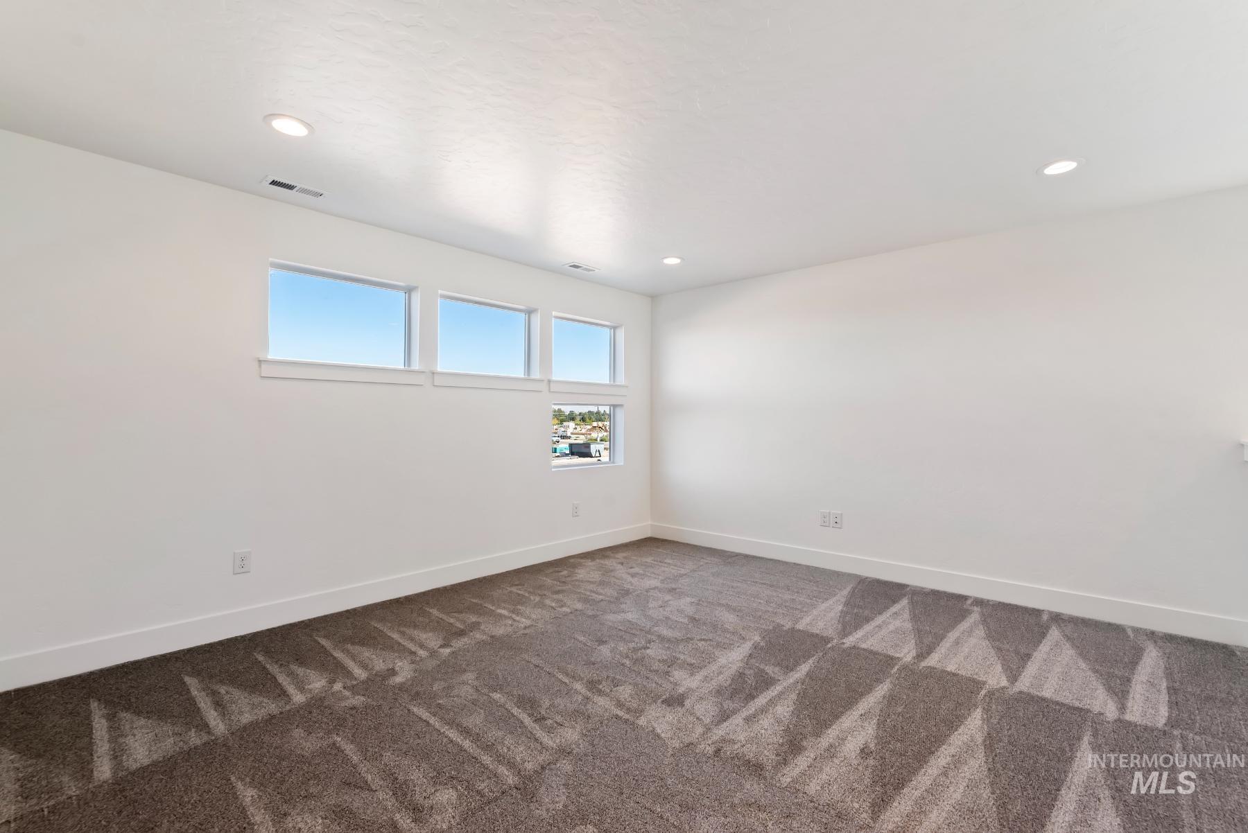 1319 West Malbar Street Meridian, ID 83646 - Photo 27 of 31 Spare room with dark carpet and recessed lighting