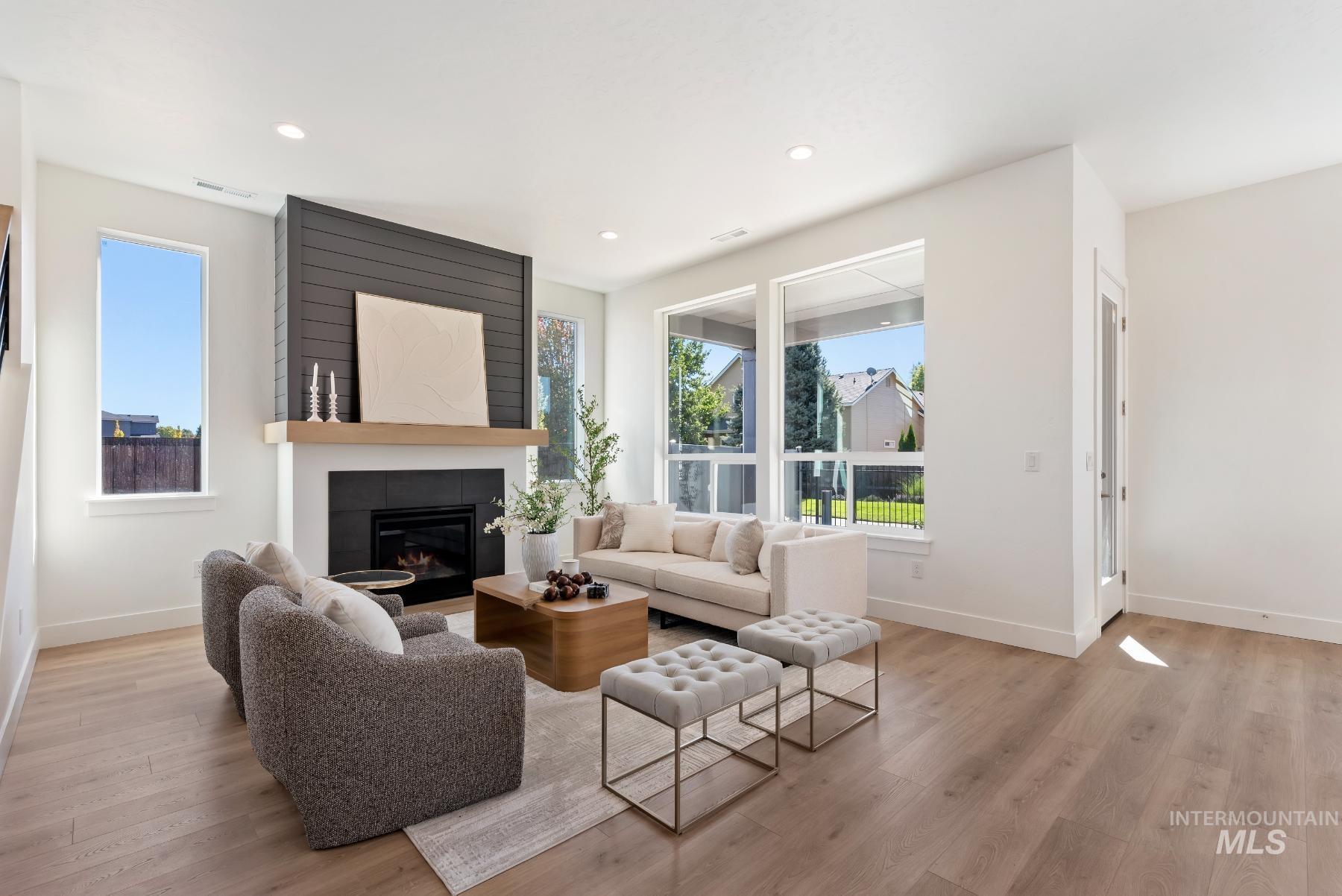 1319 West Malbar Street Meridian, ID 83646 - Photo 5 of 31 Living area with a fireplace, light wood finished floors, and recessed lighting