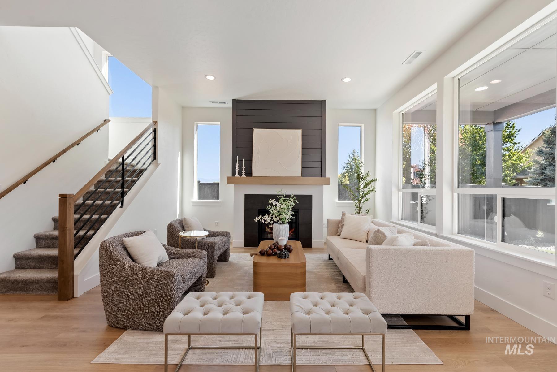 1319 West Malbar Street Meridian, ID 83646 - Photo 6 of 31 Living area featuring a large fireplace, healthy amount of natural light, light wood-style floors, stairs, and recessed lighting