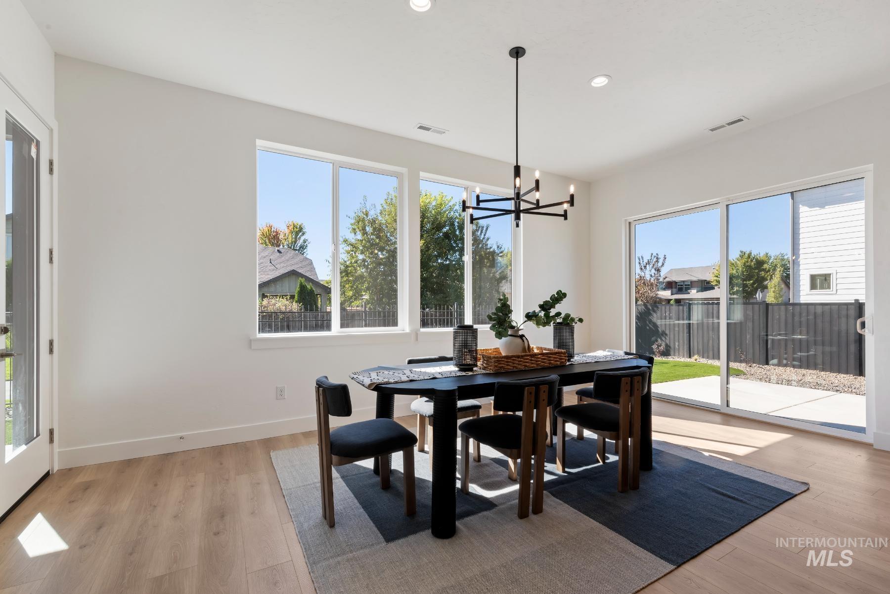 1319 West Malbar Street Meridian, ID 83646 - Photo 8 of 31 Dining area with plenty of natural light, light wood-style floors, a chandelier, and recessed lighting