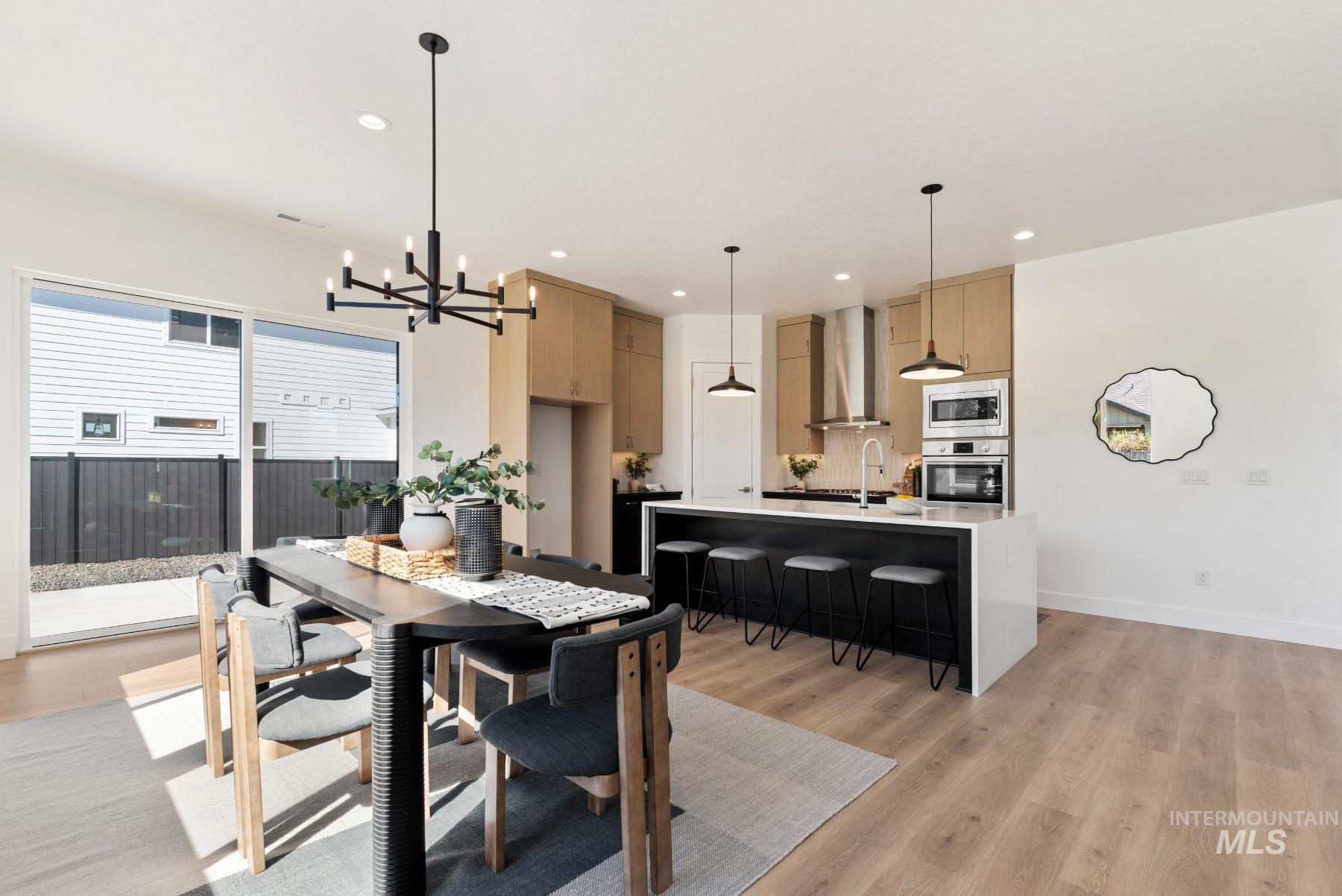 1319 West Malbar Street Meridian, ID 83646 - Photo 9 of 31 Dining space featuring light wood finished floors, a chandelier, and recessed lighting