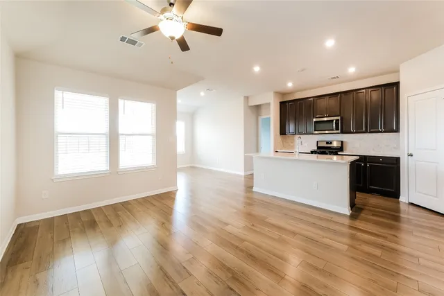 a view of kitchen with sink microwave and refrigerator