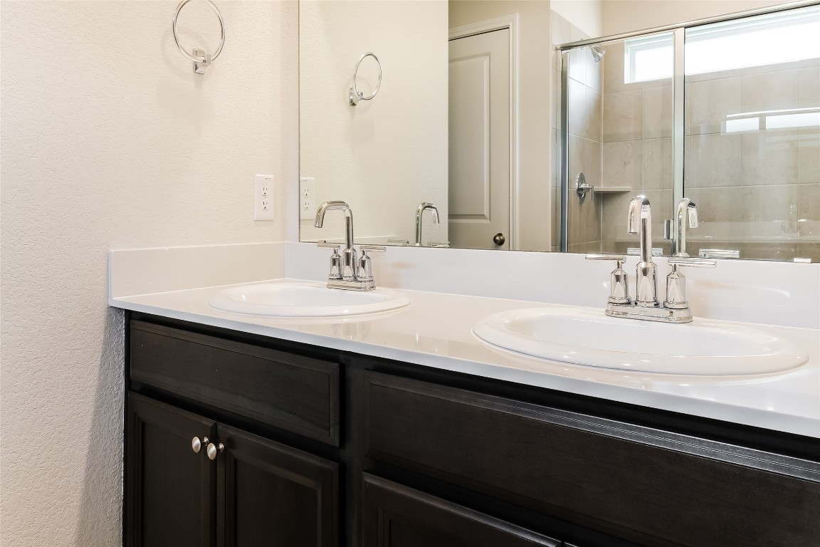 1021 Round Bale Road Hutto, TX 78634 - Photo 10 of 16 a bathroom with a sink and a mirror