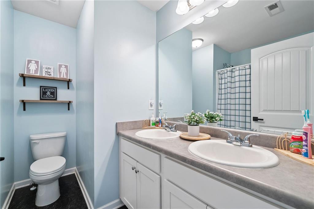 13 Four Feathers Lane Northeast Rydal, GA 30171 - Photo 39 of 51 a bathroom with a toilet sink and mirror