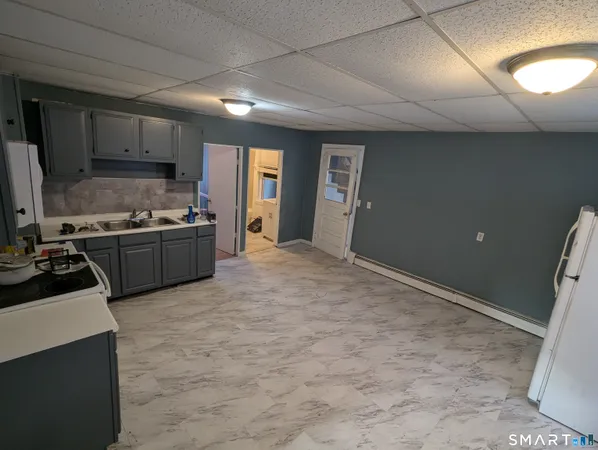a view of a kitchen with a sink and cabinets