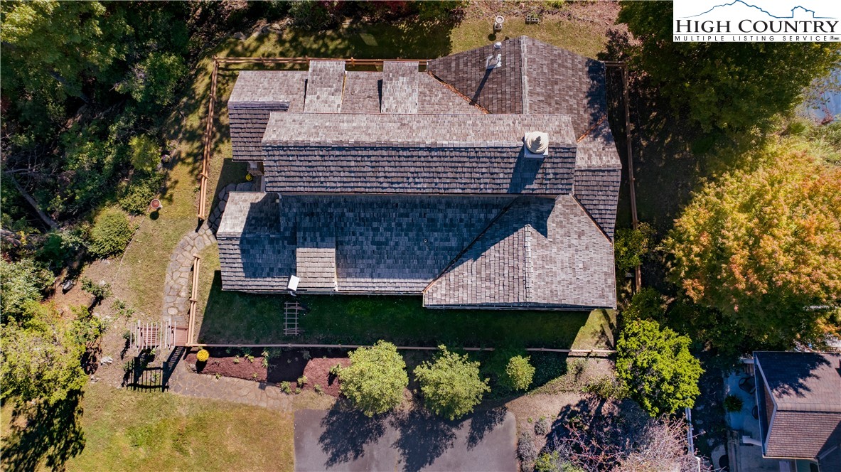 195 The Courtyard Boone, NC 28607 - Photo 14 of 16 an aerial view of a house with swimming pool and a yard