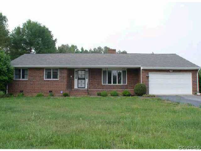 20402 Carson Road Dinwiddie, VA 23841 - Photo 1 of 1 a front view of a house with a garden