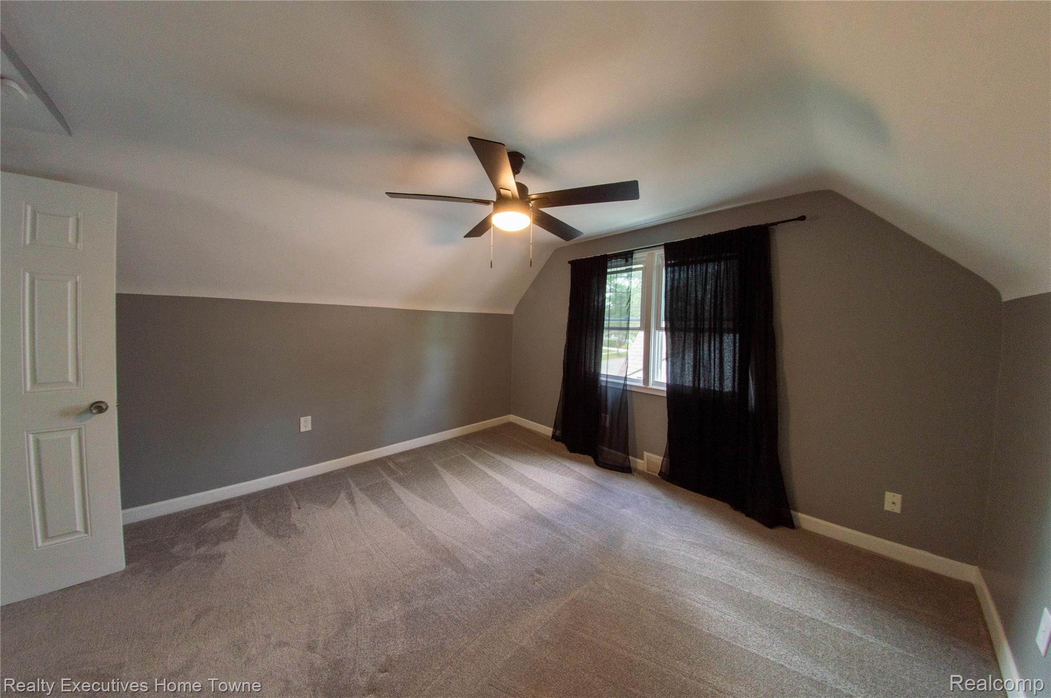 2676 Cumberland Road Berkley, MI 48072 - Photo 19 of 38 Carpeted room featuring a ceiling fan, sloped ceilings, and a window with sheer black drapery