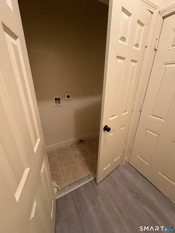 an empty room with wooden floor and white walls