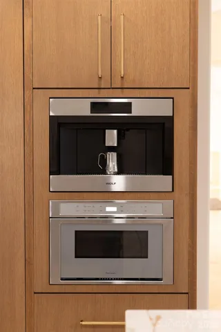 a living room with furniture a rug and a bookshelf