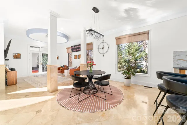 a living room with furniture and a chandelier