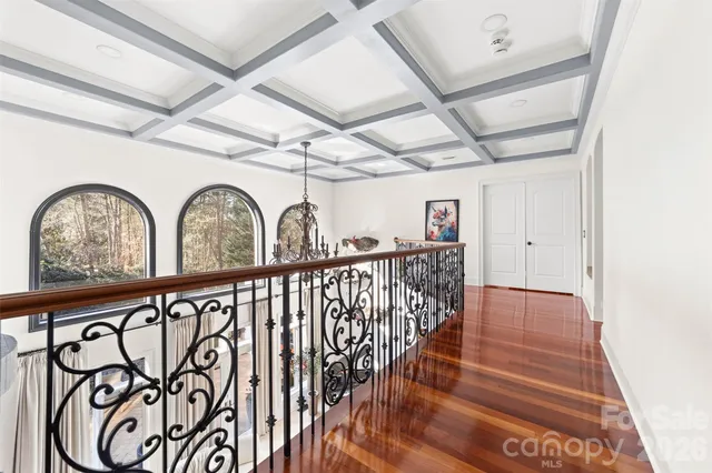 a view of a livingroom with wooden floor and a dining table
