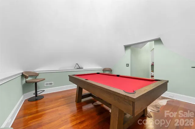 an aerial view of a house with garden space and sitting area