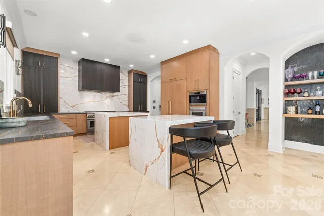 a kitchen with stainless steel appliances granite countertop a stove and a sink