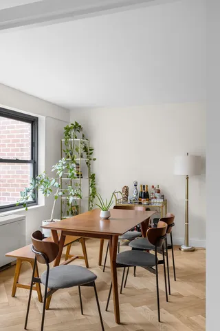 a dining room with furniture and window