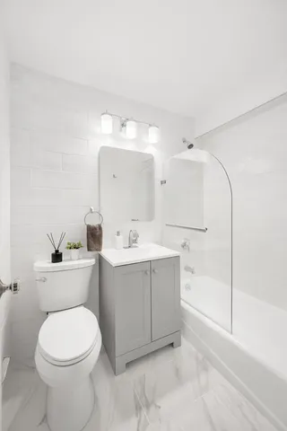 a bathroom with a sink a toilet and bathtub