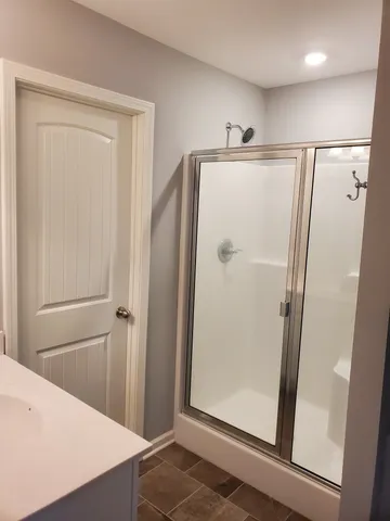 a bathroom with a shower and a mirror