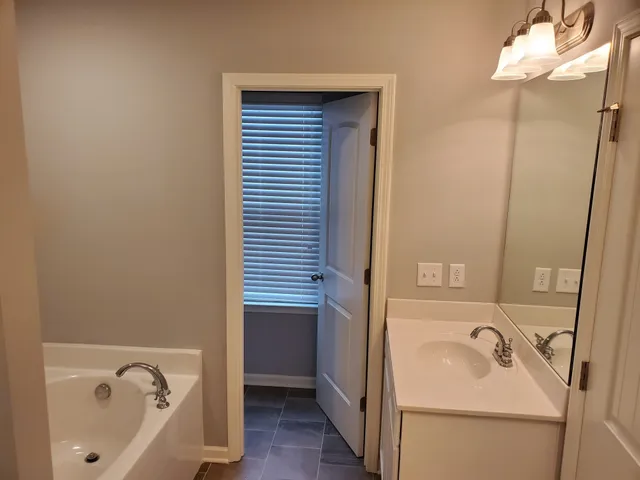 a bathroom with a bathtub and sink