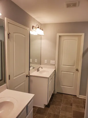 a bathroom with a sink a toilet and mirror