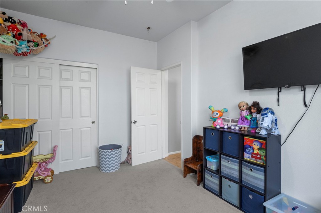7441 Clementine Drive Eastvale, CA 92880 - Photo 11 of 39 a living room with furniture and a flat screen tv