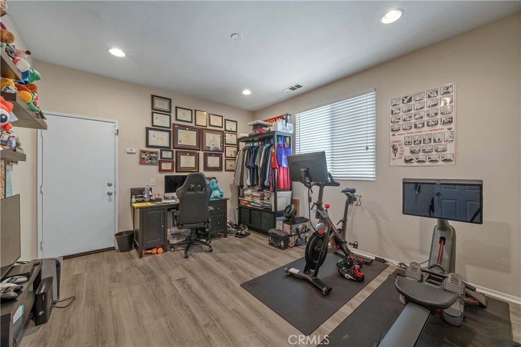 7441 Clementine Drive Eastvale, CA 92880 - Photo 17 of 39 a view of a room with gym equipment