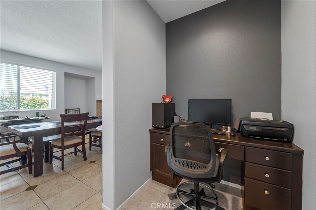 7441 Clementine Drive Eastvale, CA 92880 - Photo 19 of 39 a view of a workspace with furniture and a window