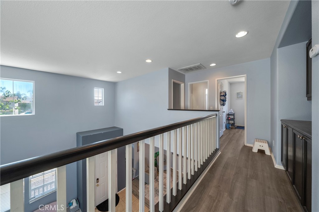 7441 Clementine Drive Eastvale, CA 92880 - Photo 20 of 39 a view of a hallway with a livingroom with furniture