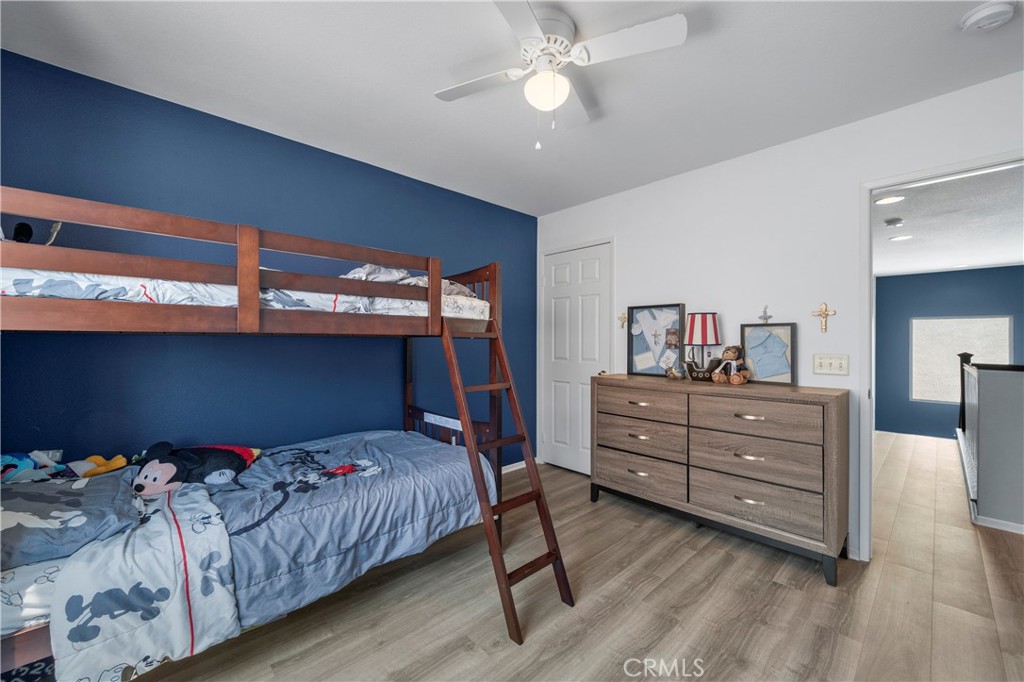 7441 Clementine Drive Eastvale, CA 92880 - Photo 24 of 39 a bedroom with a bed and large cabinets