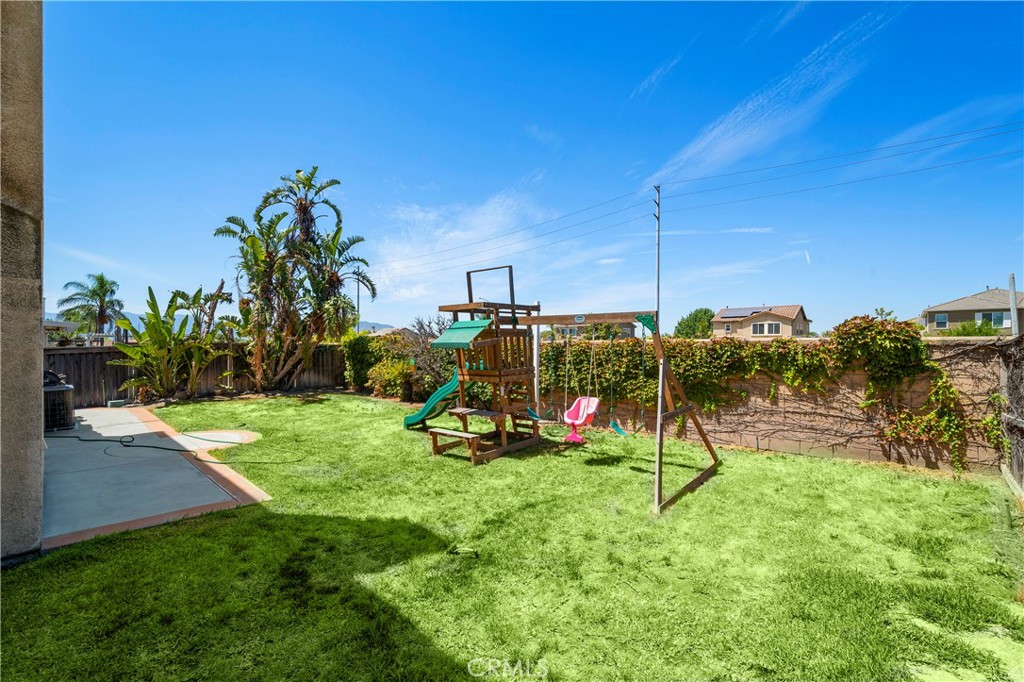 7441 Clementine Drive Eastvale, CA 92880 - Photo 32 of 39 a view of a park with swings and slides