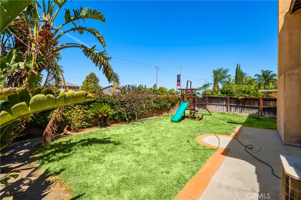 7441 Clementine Drive Eastvale, CA 92880 - Photo 34 of 39 a view of a garden with a slide