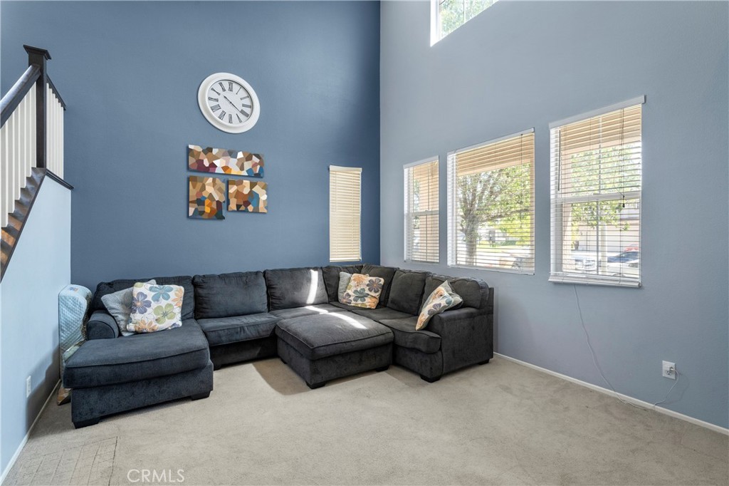 7441 Clementine Drive Eastvale, CA 92880 - Photo 4 of 39 a living room with furniture and a window