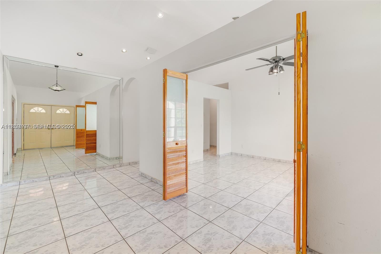 19900 Southwest 326th Street Homestead, FL 33030 - Photo 8 of 15 a view of a hallway with closet and mirror