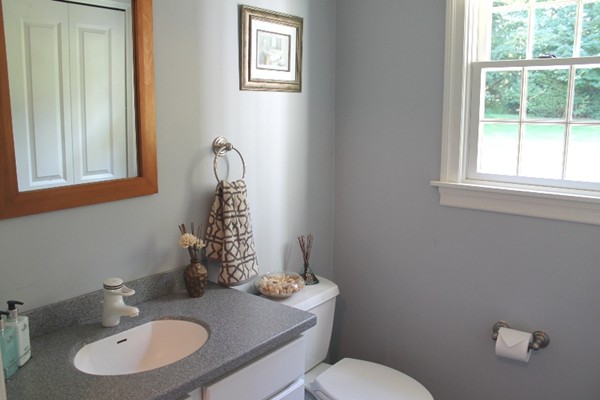 23 Wyman Road Lexington, MA 02420 - Photo 12 of 30 a bathroom with a granite countertop toilet sink and mirror