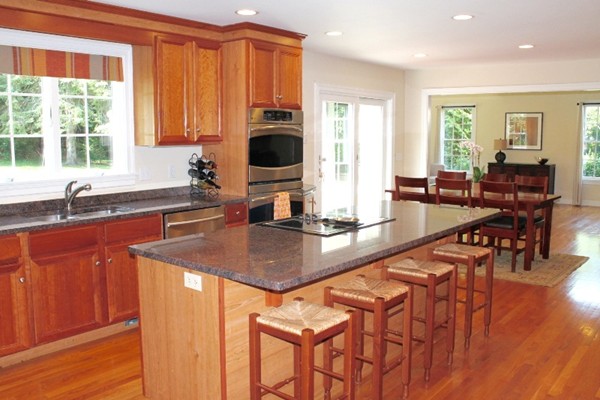 23 Wyman Road Lexington, MA 02420 - Photo 8 of 30 a kitchen with stainless steel appliances granite countertop a sink a stove and a refrigerator
