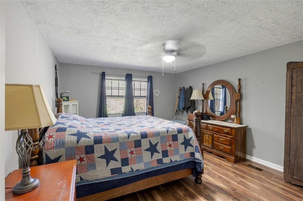 5948 Haywood Valley Road Summerville, GA 30747 - Photo 11 of 74 a bedroom with a bed and wooden floor